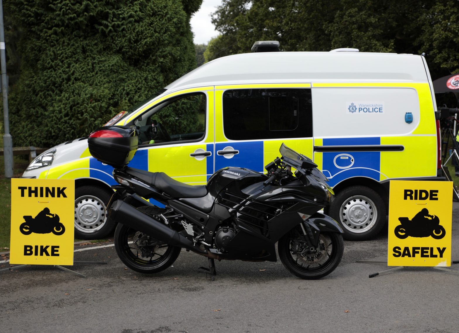 THINK BIKE signage with a police van and motorbike