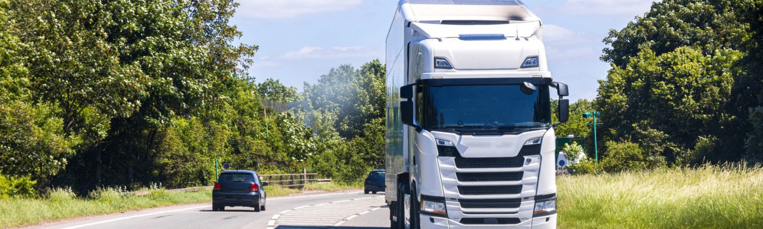 A large HGV vehicle traveling along one of the main road routes of the United Kingdom,